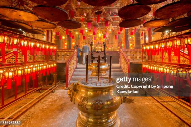 unknown asian prayers are praying inside the man mo temple - couple praying stock pictures, royalty-free photos & images