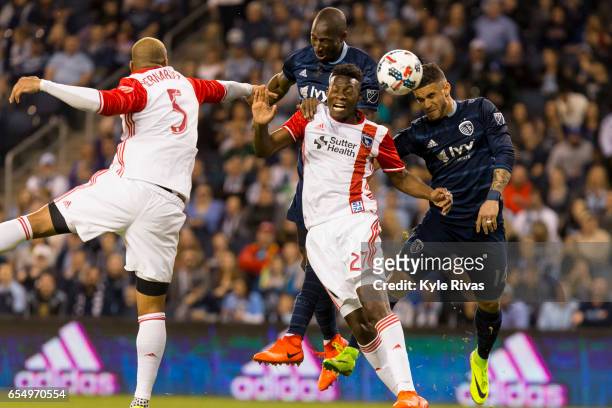 Victor Bernardez and Fatai Alashe of San Jose Earthquakes attempt to fend off Dom Dwyer and Ike Opara of Sporting Kansas City early in the first half...