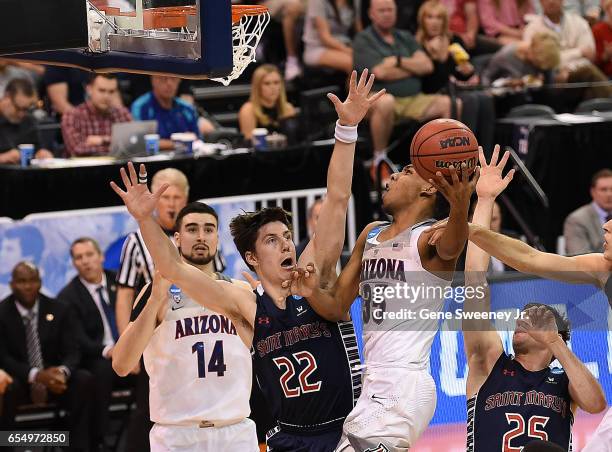 Allonzo Trier of the Arizona Wildcats attempts a shot defended by Dane Pineau of the St. Mary's Gaels during the second round of the 2017 NCAA Men's...