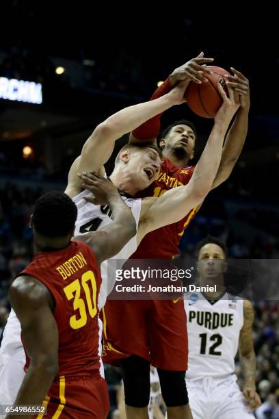 Isaac Haas of the Purdue Boilermakers battles for a rebound against Deonte Burton and Darrell Bowie of the Iowa State Cyclones in the first half...