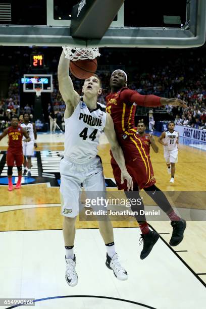 Isaac Haas of the Purdue Boilermakers dunks the ball while being guarded by Solomon Young of the Iowa State Cyclones in the first half during the...
