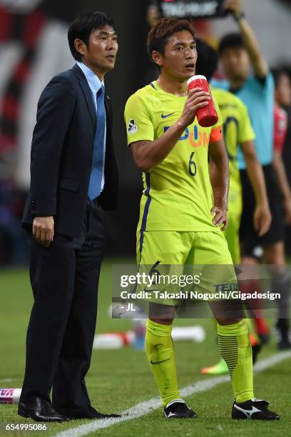 Head coach Hajime Moriyasu of Sanfrecce Hiroshima talks to Toshihiro Aoyama during the J.League J1 match between Consadole Sapporo and Sanfrecce...