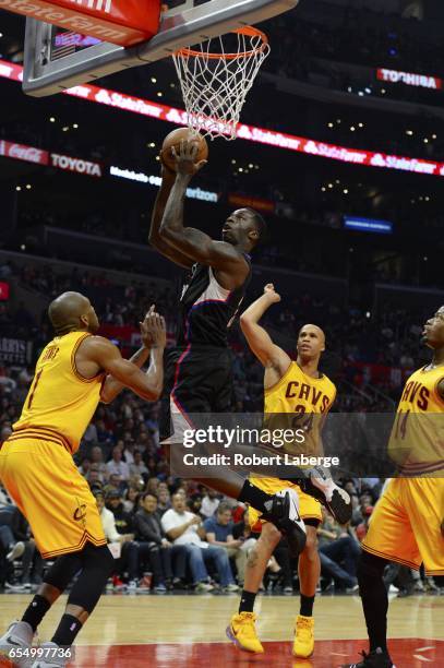 Brandon Bass of the Los Angeles Clippers attempts a lay up against James Jones, Richard Jefferson and DeAndre Liggins of the Cleveland Cavaliers on...