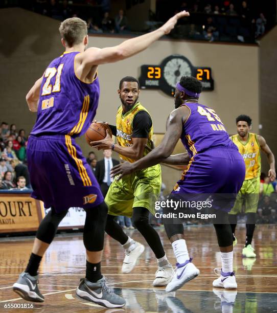 Jabril Trawick from the Sioux Falls Skyforce looks for a teammate between a pair of defenders including DeJuan Blair from the Los Angeles D-Fenders...