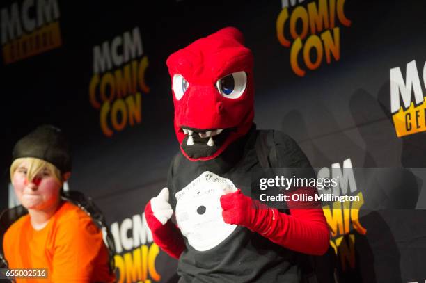 Cosplayer performs as the pokemon Charizard at the end of day 1 during the MCM Birmingham Comic Con at NEC Arena on March 18, 2017 in Birmingham,...