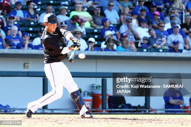 Seiji Kobayashi of Japan hits a single in the top half of the eigth inning during the exhibition game between Japan and Chicago Cubs at Sloan Park on...