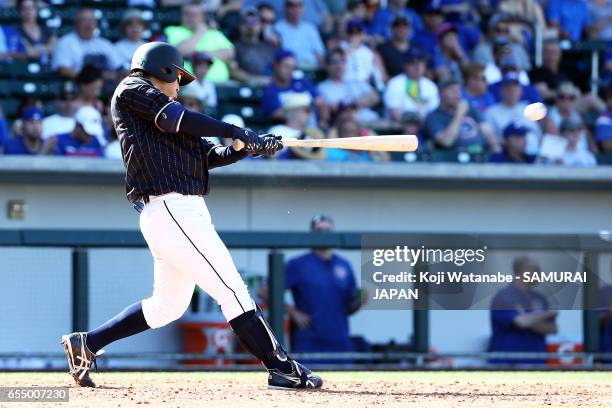 Kosuke Tanaka of Japan hits a single in the top half of the eigth inning during the exhibition game between Japan and Chicago Cubs at Sloan Park on...