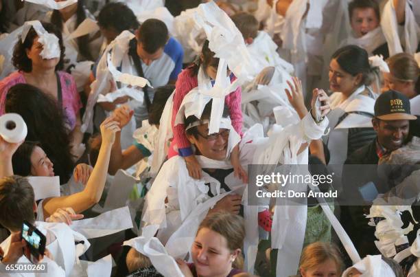 Girl sits on her fathers shoulders at Powerhouse Museum on March 19, 2017 in Sydney, Australia. A total of 846 people wrapped themselves in toilet...