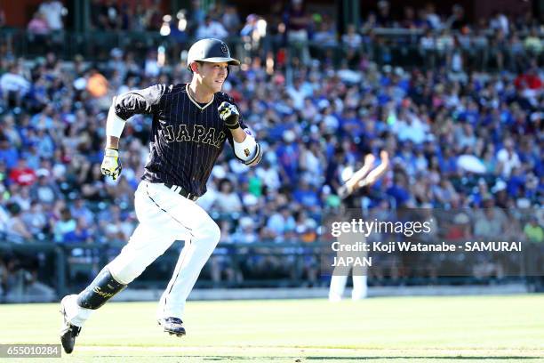 Seiji Kobayashi of Japan hits a single in the top half of the eigth inning during the exhibition game between Japan and Chicago Cubs at Sloan Park on...