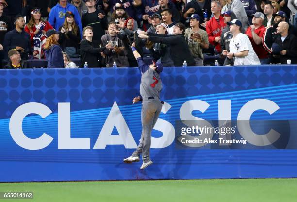 Christian Yelich of Team USA can't make the catch as Robinson Cano of Team Dominican Republic hits a home run in the bottom of the seventh inning of...