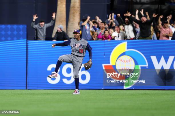 Adam Jones of Team USA reacts after making a leaping catch to rob Manny Machado of Team Dominican Republic of a home run in the bottom of the seventh...
