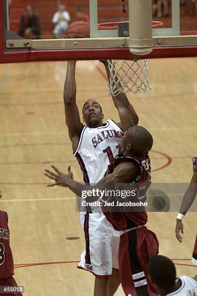 Sylvester Willis of Southern Illinois shoots over Jacova Jenkins of Troy State during the Yahoo! Sports Invitational at the BYU-Hawaii Cannon...