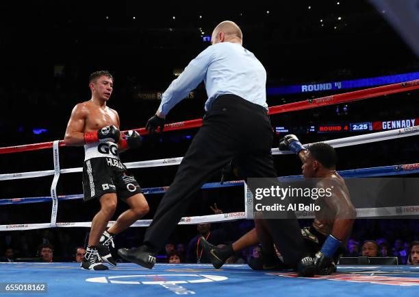 Gennady Golovkin knocks down Daniel Jacobs in the fourth round during their Championship fight for Golovkin's WBA/WBC/IBF middleweight title at...