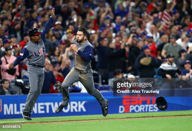 Eric Hosmer of Team USA is waved home by third base coach Willie Randolph as he rounds the bases to score in the top of the eighth inning of Game 6...