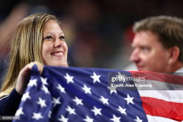 Fan smiles and holds up an American flag during Game 6 of Pool F of the 2017 World Baseball Classic between Team USA and Team Dominican Republic on...