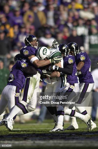 Robert Bailey, Rod Woodson, James Trapp and Duane Starks the Baltimore Ravens gang tackle Wayne Chrebet of the New York Jets during first half action...