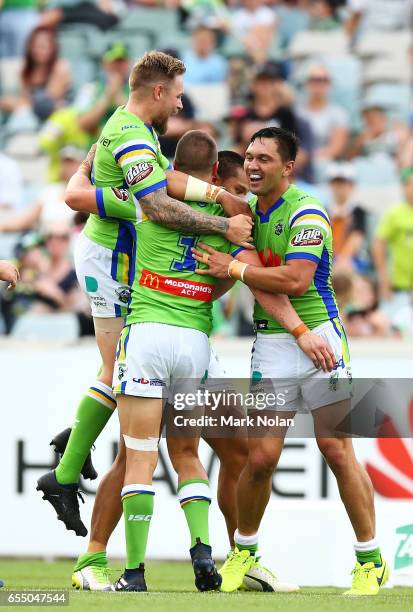 Jack Wighton of the Raiders celebrates his try with team mates during the round three NRL match between the Canberra Raiders and the Wests Tigers at...