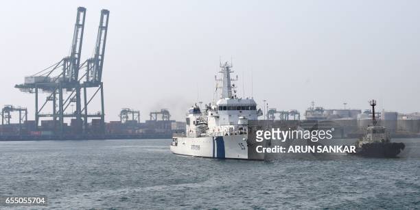 Indian Coast Guard Ship Shaunak a new offshore patrol vessel is escorted by a tug as she arrives at port in Chennai on March 19 making her maiden...