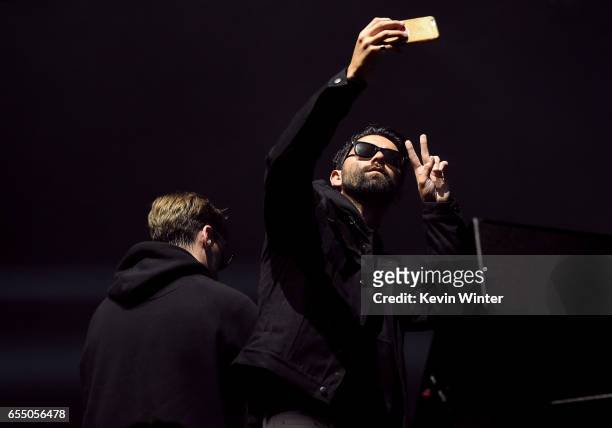 Jim Aasgier and Nizzle of Yellow Claw take a selfie onstage during AMPLIFY 2017 presented by 97.1 AMP Radio at The Shrine Expo Hall on March 18, 2017...
