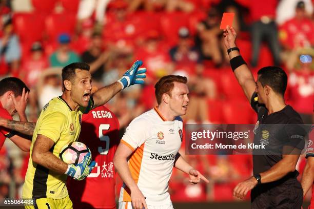 Michael Theo of Brisbane Roar reacts after receiving a red card from referee Stephen Lucas during the round 23 A-League match between Adelaide United...