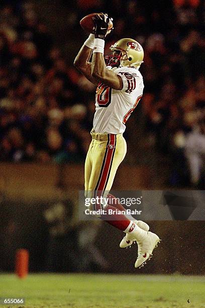 Jerry Rice of the San Francisco 49ers makes a leaping catch, in perhaps his final game as a 49er, at the end of the game against the Denver Broncos...