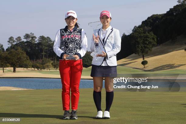 Minami Katsu of Japan and Erika kikuchi of Japan pose with the trophy after winning the T-Point Ladies Golf Tournament at the Wakagi Golf Club on...