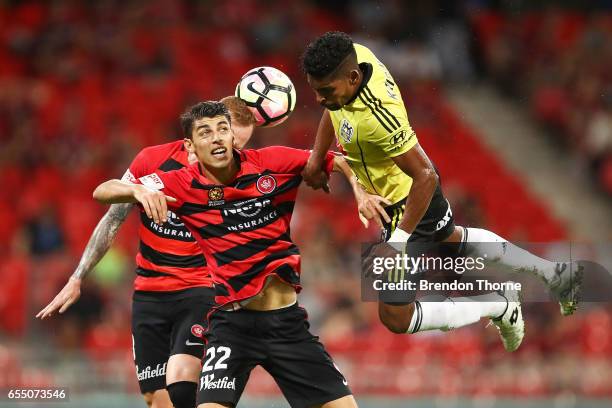 Roy Krishna of the Phoenix flies through the air to compete for a header with Jonathan Aspropotamitis and Jack Clisby of the Wanderers during the...