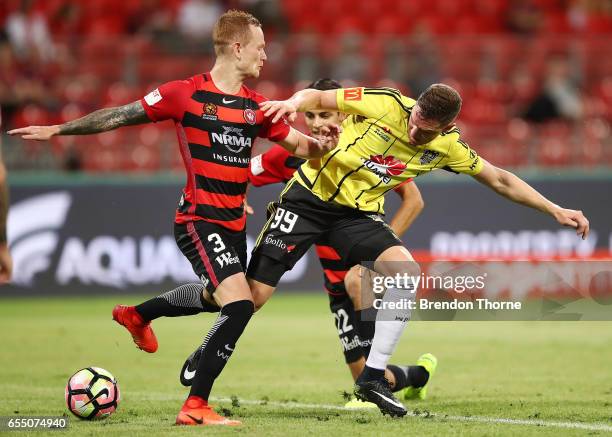 Shane Smeltz of the Phoenix competes with Jack Clisby and Jonathan Aspropotamitis of the Wanderers during the round 23 A-League match between the...