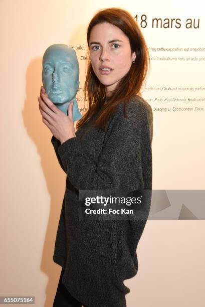 Actress /model Zoe Duchesne poses with Sarah Trouche's chocolate face sculpture during the 'Faccia A Faccia' Sarah Trouche performance exhibition at...