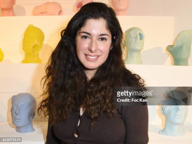 Visual artist Sarah Trouche poses with her work during the 'Faccia A Faccia' Sarah Trouche performance exhibition at Galerie Vanessa Quang on March...