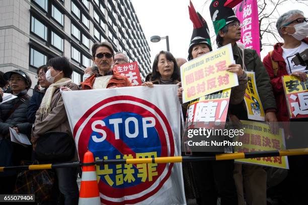 Anti-Abe protesters gather with placards and banners in front of Tokyo parliament during a rally, denouncing his government policies and calling on...