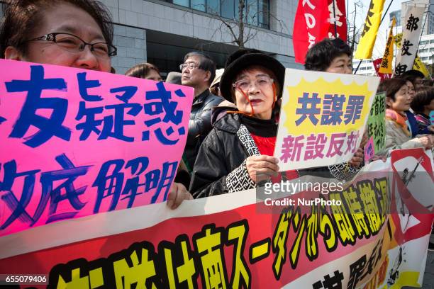 Anti-Abe protesters gather with placards and banners in front of Tokyo parliament during a rally, denouncing his government policies and calling on...
