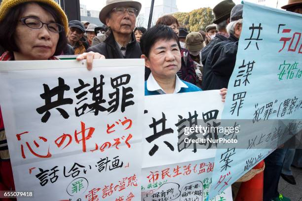 Anti-Abe protesters gather with placards and banners in front of Tokyo parliament during a rally, denouncing his government policies and calling on...