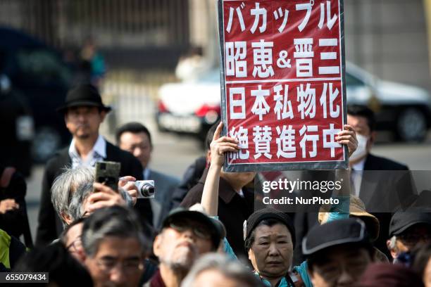 Anti-Abe protesters gather with placards in front of Tokyo parliament during a rally, denouncing his government policies and calling on the Japanese...