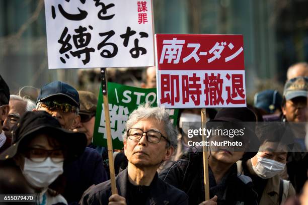 Anti-Abe protesters gather with placards in front of Tokyo parliament during a rally, denouncing his government policies and calling on the Japanese...