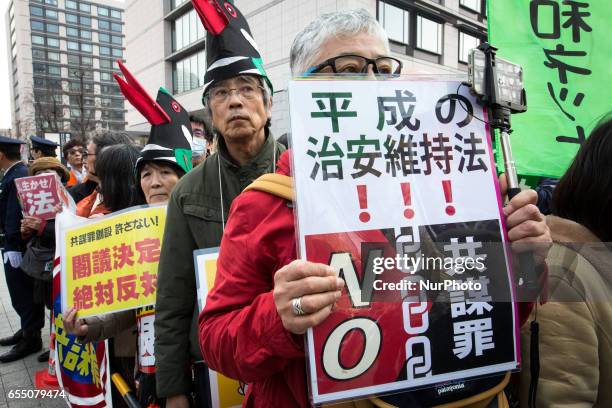 Anti-Abe protesters gather with placards in front of Tokyo parliament during a rally, denouncing his government policies and calling on the Japanese...