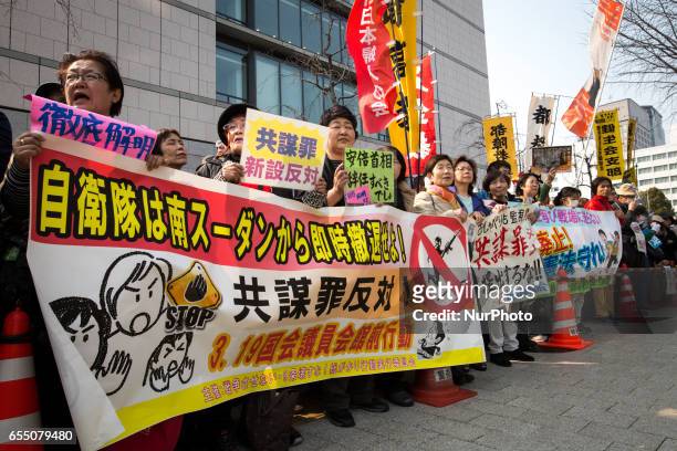 Anti-Abe protesters gather with placards and banners in front of Tokyo parliament during a rally, denouncing his government policies and calling on...