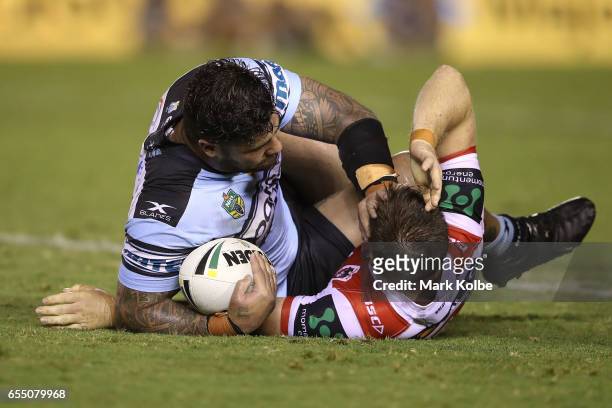 Andrew Fifita of the Sharks pushes away Josh McCrone of the Dragons after being tackled during the round three NRL match between the Cronulla Sharks...