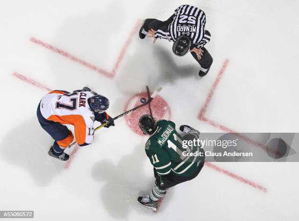 Everett Clark of the Flint Firebirds takes a faceoff against Owen MacDonald of the London Knights during an OHL game at Budweiser Gardens on March...