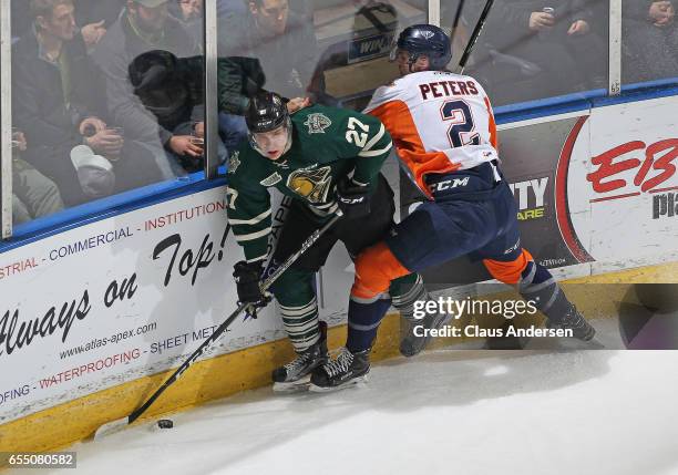 Alex Peters of the Flint Firebirds battles against Robert Thomas of the London Knights during an OHL game at Budweiser Gardens on March 17, 2017 in...