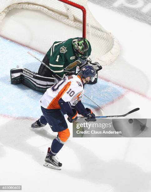 Nicholas Caamano of the Flint Firebirds looks to get a shot at Tyler Parsons of the London Knights during an OHL game at Budweiser Gardens on March...