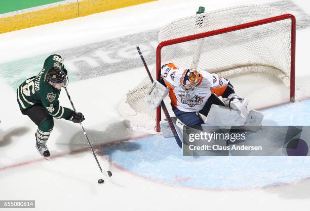 Connor Hicks of the Flint Firebirds gets set to face a scoring attempt by Dante Salituro of the London Knights during an OHL game at Budweiser...
