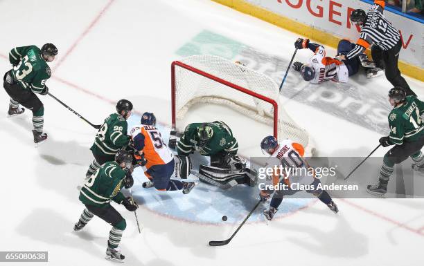 Ryan Moore of the Flint Firebirds is about to get stopped by Tyler Parsons of the London Knights during an OHL game at Budweiser Gardens on March 17,...