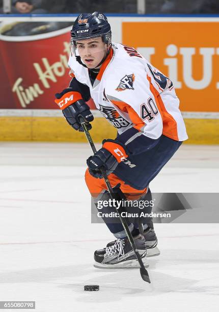 Ryan Moore of the Flint Firebirds skates with the puck against the London Knights during an OHL game at Budweiser Gardens on March 17, 2017 in...