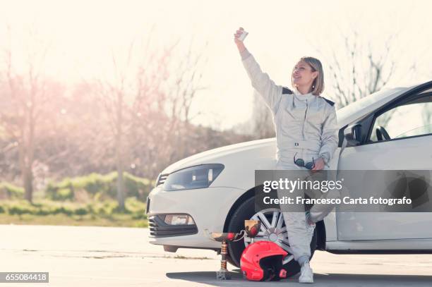 young female driver - rennfahrer stock-fotos und bilder