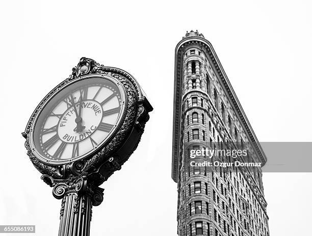 flatiron building and fifth avenue clock - flatiron building manhattan stock pictures, royalty-free photos & images