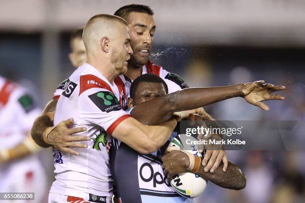 Euan Aitken and Paul Vaughan of the Dragons tackle Edrick Lee of the Sharks during the round three NRL match between the Cronulla Sharks and the St...