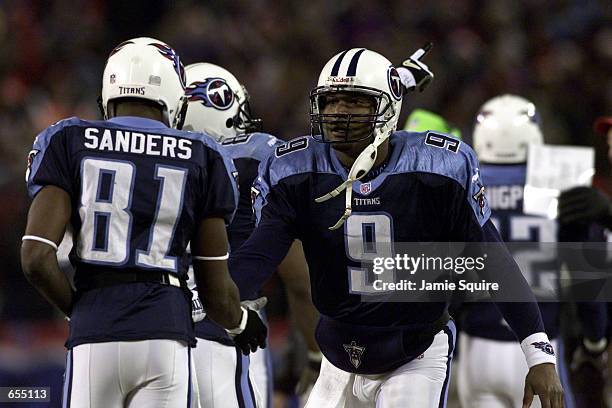 Quarterback Steve McNair of the Tennessee Titans congratulates Derrick Mason and Chris Sanders following a touchdown during the first quarter against...