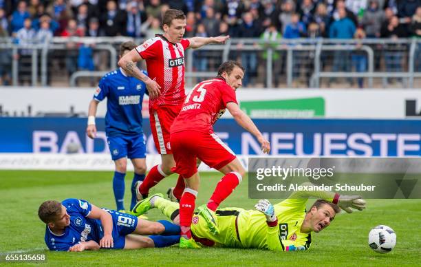Grischa Proemel of Karlsruhe challenges Michael Rensing of Fortuna Duesseldorf during the Second Bundesliga match between Karlsruher SC and Fortuna...