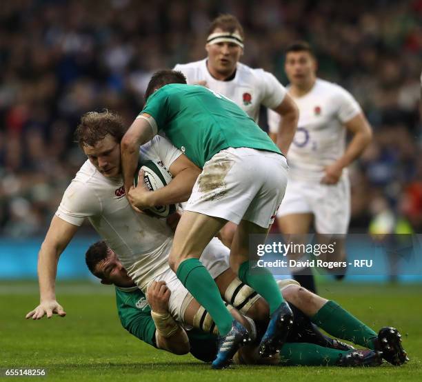 Joe Launchbury of England is tackled during the RBS Six Nations match between Ireland and England at the Aviva Stadium on March 18, 2017 in Dublin,...